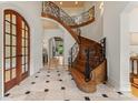 Elegant foyer with curved staircase, iron railings, and marble floors at 277 Tradition Dr, Mount Gilead, NC 27306