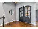 Entryway featuring double doors, wood floors, and gray walls with white trim at 2817 Lakefront Dr, Belmont, NC 28012