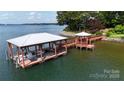 Large boat dock with gazebo and boat lift on a waterfront property at 2818 Cherry Ln, Denver, NC 28037