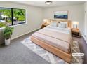 Staged bedroom with a large window and modern décor providing a calming and serene atmosphere at 3143 Windbluff Dr, Charlotte, NC 28277