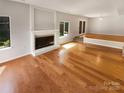Bright, open living room with hardwood floors, fireplace, and sliding door to the outdoors, perfect for entertaining at 3143 Windbluff Dr, Charlotte, NC 28277