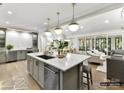 Open-concept kitchen with a large island, stainless steel appliances, and seamless flow to the living area at 4015 Pritchard Pl, Fort Mill, SC 29715