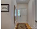 Inviting foyer featuring hardwood floors, a stylish rug, and ample natural light, creating a warm welcome at 433 Linsbury Ct, Gastonia, NC 28056