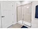 Bright bathroom featuring a glass enclosed walk-in shower and a white door at 5112 Larewood Dr, Charlotte, NC 28215