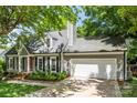Gray exterior elevation featuring a two-car garage and meticulous landscaping at 540 Garrison Sw Ct, Concord, NC 28025