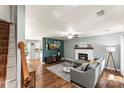 Sunlit living room with fireplace, ceiling fan, hardwood floors, and comfortable seating at 540 Garrison Sw Ct, Concord, NC 28025