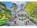 Beautiful brick home with manicured landscaping, a charming fountain, and a welcoming entrance at 6005 Bryant Ln, Waxhaw, NC 28173