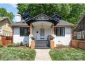 Charming renovated two-story home featuring a freshly painted white brick exterior and inviting front porch at 624 Oakland Ave, Charlotte, NC 28204