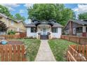 Beautiful two-story house with a picket fence, green lawn, and inviting facade at 624 Oakland Ave, Charlotte, NC 28204