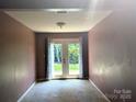 Empty room featuring neutral walls and French doors leading to the exterior, perfect for natural light at 711 4Th Sw Ave # B3, Conover, NC 28613