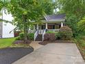 Beautifully landscaped home with a cozy front porch, offering a blend of charm and curb appeal at 716 Ellsworth Rd, Charlotte, NC 28211