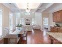 Open-concept living space with coffered ceilings, fireplace, and hardwood flooring at 7722 Springs Village Ln # 40, Charlotte, NC 28226