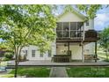 Backyard view featuring a patio with a built-in bar, porch swing and an upper screened porch at 7730 Windsor Forest Pl, Harrisburg, NC 28075