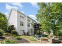Spacious backyard showcasing a patio with a fire pit, and a view of the screened porch at 7730 Windsor Forest Pl, Harrisburg, NC 28075