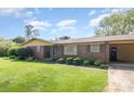 Charming brick home featuring a well-manicured lawn and covered carport at 812 Clinton Ave, Lancaster, SC 29720