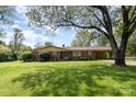 Charming brick home featuring a well-manicured lawn and covered carport at 812 Clinton Ave, Lancaster, SC 29720