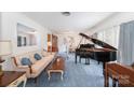 Elegant living room with a grand piano, plush seating, and traditional decor showcasing refined style at 812 Clinton Ave, Lancaster, SC 29720