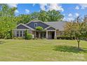 Inviting single-Gathering home featuring beautiful landscaping, well-manicured lawn, and charming architectural details at 907 Lingfield Ln, Waxhaw, NC 28173