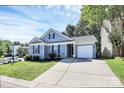 Charming single-story home with a well-manicured lawn and attached one car garage at 9212 Scotts Elm Ct, Charlotte, NC 28215