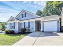 Charming single-story home with a well-manicured lawn and attached one car garage at 9212 Scotts Elm Ct, Charlotte, NC 28215