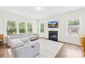Open living room offers a fireplace, large windows, recessed lighting, and comfortable seating at 106 Kirsche Ct, Mooresville, NC 28115