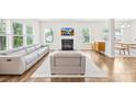 Inviting living room features recessed lights, large windows, a fireplace, and modern furniture at 106 Kirsche Ct, Mooresville, NC 28115