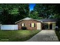 Charming single-story brick home featuring a well-manicured lawn and a convenient carport at 11 N 10Th Ave, Maiden, NC 28650