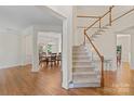 Bright entryway with hardwood floors, staircase, and formal dining room access at 111 Wilton Pl, Mooresville, NC 28117