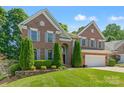 Charming brick home with lush front lawn, tasteful landscaping, and gray shutters at 111 Wilton Pl, Mooresville, NC 28117