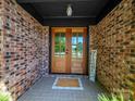 Inviting front entrance with double wooden doors and brick facade at 1207 Carlson Dr, Monroe, NC 28110