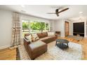 Bright living room with comfortable seating, large window, and hardwood floors at 1207 Carlson Dr, Monroe, NC 28110