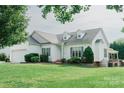 Charming one story home with well maintained lawn and landscaped garden beds at 135 Meadow Lake Dr, Salisbury, NC 28146