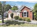 Brick and siding home showcasing professional landscaping around the house and garage at 13612 Bolingbrook Ln, Charlotte, NC 28273