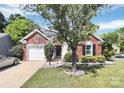 Charming brick and siding home with landscaped front yard and an attached garage at 13612 Bolingbrook Ln, Charlotte, NC 28273