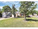 Well maintained yard features brick and siding exterior of the house, plus large trees at 13612 Bolingbrook Ln, Charlotte, NC 28273