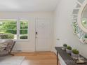 Inviting entryway with hardwood floors, white walls, and natural light at 1422 Burnley Rd, Charlotte, NC 28210