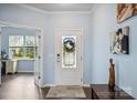 Bright foyer featuring a decorative front door, wood floors, and view to office at 16038 Harbor Hill Dr, Charlotte, NC 28273