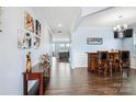 Long hallway with elegant décor, chair rail detail, bar area, and access to living room at 16038 Harbor Hill Dr, Charlotte, NC 28273