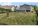 A spacious, fenced backyard with lush grass and a patio area, ideal for outdoor gatherings and relaxation at 17513 Julees Walk Ln, Davidson, NC 28036