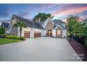 Beautiful home with three-car garage, stone accents, and a spacious driveway at 17819 John Connor Rd, Cornelius, NC 28031