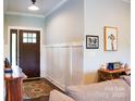 Inviting foyer with wood-look flooring, paneled walls, and a stylish front door with glass panes at 179 Foy Ln, Statesville, NC 28625