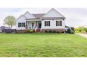Spacious lawn enhances this two-story home with a charming front porch and contrasting shutters at 179 Foy Ln, Statesville, NC 28625