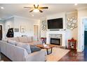 Cozy living room featuring a fireplace, large sectional sofa, and modern decor at 179 Foy Ln, Statesville, NC 28625