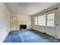 Living room featuring a fireplace and large window at 191 Scenic Ne Dr, Concord, NC 28025
