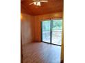 Bedroom featuring wood paneling, sliding glass doors to a deck, and light hardwood flooring at 201 Trinity St, Clover, SC 29710