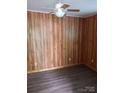 Bedroom featuring wood paneling, a ceiling fan, and vinyl flooring at 201 Trinity St, Clover, SC 29710