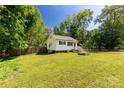 Quaint single-story house featuring a lush green lawn and well-kept garden beds at 201 Trinity St, Clover, SC 29710