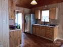 A cozy kitchen with wood paneling, stainless steel appliances, and ample cabinet space at 201 Trinity St, Clover, SC 29710
