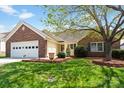 Charming single-story home featuring a brick facade, well-manicured lawn and attached garage with carriage door at 202 Pond View Dr, Salisbury, NC 28147