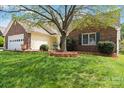 Charming single-story home featuring a brick facade, well-manicured lawn and attached garage with carriage door at 202 Pond View Dr, Salisbury, NC 28147